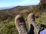 Photograph of hills with walking boots in foreground