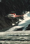 Decorative photograph showing helicopter over glacier